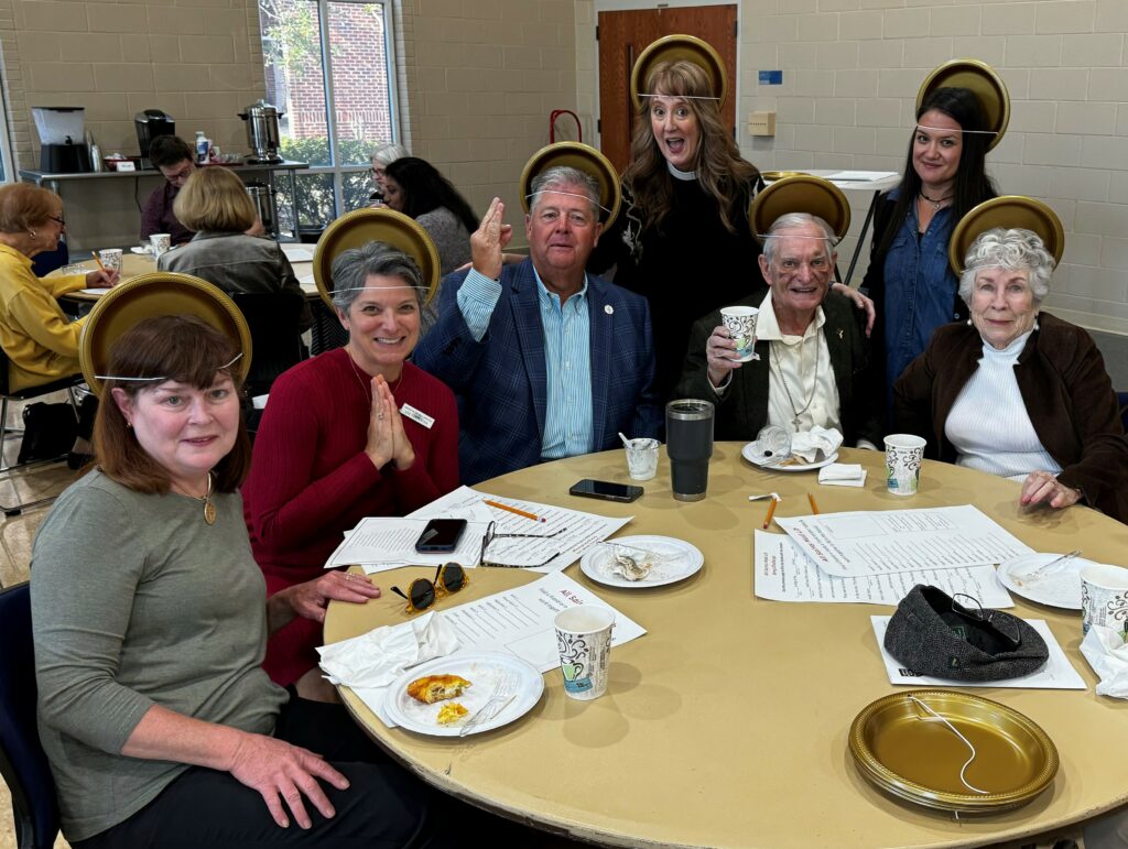 Parishioners make saint halos from paper plates for a fundraiser